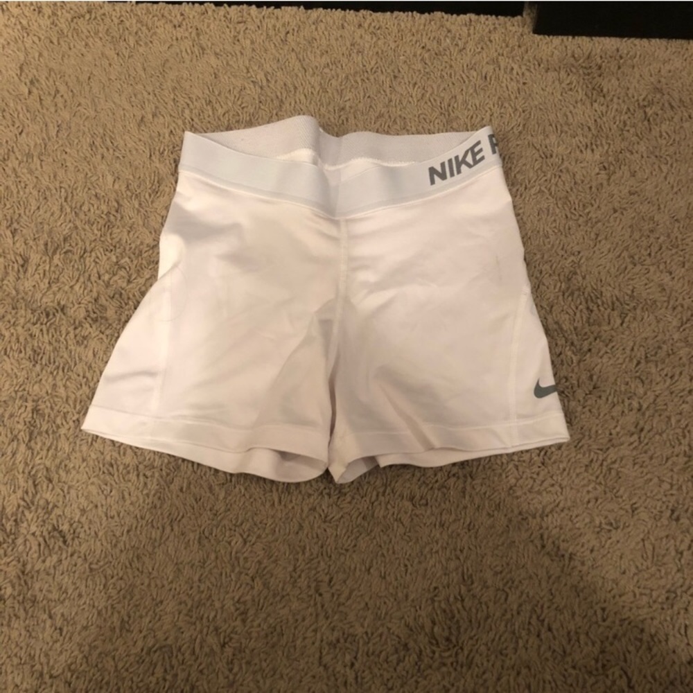 White Nike pros in a size medium